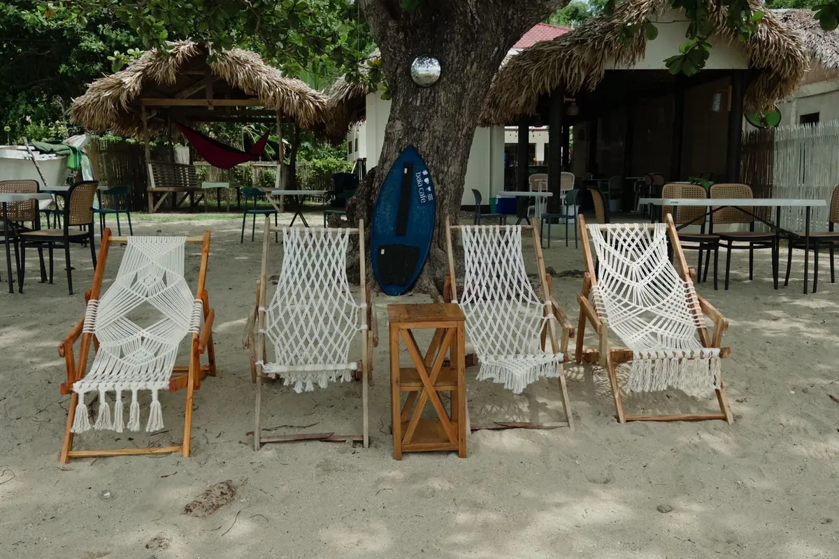 BAIA beachfront lounge chairs and umbrellas on white sand
