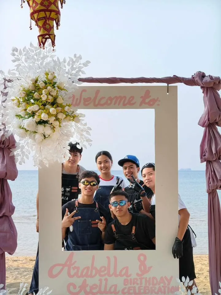 Team BAIA cafe crew wearing brand aprons by the beach
