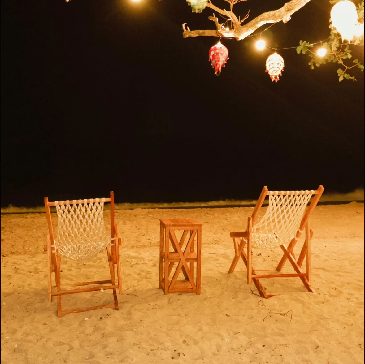 BAIA beachfront dining tables and twilight coastal ambience on the sand